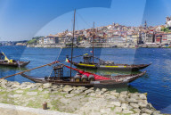 Porto, Portugal Vila Nova de Gaia waterfront ships. Douro river moored ships used to carry Porto wine with Ribeira background.