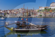 Porto, Portugal Vila Nova de Gaia waterfront ships. Douro river moored ships used to carry Porto wine with Ribeira background.