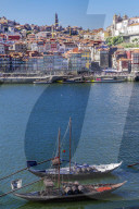 Porto, Portugal Vila Nova de Gaia waterfront ships. Douro river moored ships used to carry Porto wine with Ribeira background.