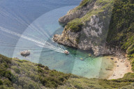 High-angle view down to one of the Porto Timoni beaches and a taxi boat approaching the bay, Afionas, Corfu, Greece, Europe