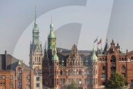 Historical buildings in the Speicherstadt (UNESCO World Heritage Site) with the town hall in the background, Hamburg, Germany