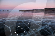 Lake Baikal in winter ice at sunset