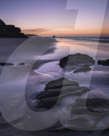 Dawn twilight with clouds on the beach at Orcombe Point, the Western end of the Jurassic Coast, Exmouth, Devon, UK.