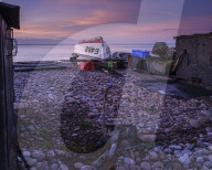 Turning block and boat on the pebbled beach at Budliegh Salterton, Devon, UK