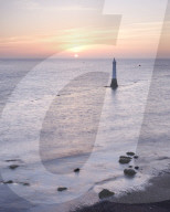 Sunrise across Torbay with the Navigation mark at the entrance to the River Teign, viewed from Shaldon, Devon, UK