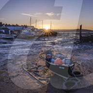 The sun sets behind the boats at Camperdown, Exmouth, Devon , UK