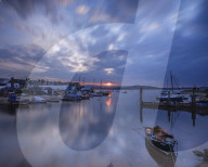 Sunset with boats on the Exe shoreline at the back of Camperdown Terrace, Exmouth, Devon, UK