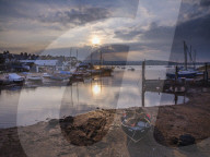 Sunset with boats on the Exe shoreline at the back of Camperdown Terrace, Exmouth, Devon, UK