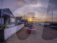 Sunset with boats on the Exe shoreline at the back of Camperdown Terrace, Exmouth, Devon, UK