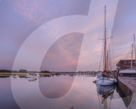 Turf Ferry and other boats moored on a mirror calm River Exe at Topsham, Devon, UK
