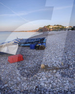 Fishing boats and gear on the pebbled beach at Budliegh Salterton, Devon, UK