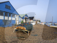 Sunshine with mist over the River Exe enhances this scene of boats and the sailmaker's loft, Exmouth, Devon, UK