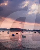 Sun sets over Starcross across the River Exe, Exmouth, Devon, UK
