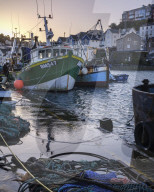 High tide at dawn in the harbour of the fishing port of Brixham, Devon, UK
