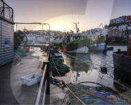 High tide at dawn in the harbour of the fishing port of Brixham, Devon, UK
