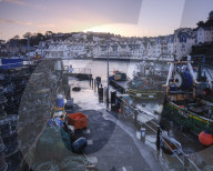 High tide at dawn in the harbour of the fishing port of Brixham, Devon, UK