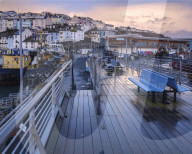 Wet teak decking and benches of the elevated nautical viewpoint for the harbour of Brixham, Devon, UK