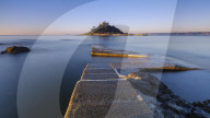 Sunrise on the boat jetty with warm light at St Michael's Mount in Marazion, Cornwall, UK