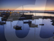Sunrise looking across the inner and outer harbours at the fishing port of Newlyn, Cornwall, UK.