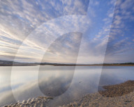 Looking North up the Exe estuary with interesting clouds and reflections from Exmouth, Devon, UK