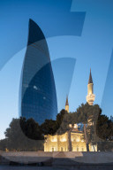 Exterior of The Shahid Mosque with Flame Towers in background at night, Baku, Azerbaijan