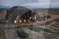 Brick workers firing a kiln near Antsirabe, Vakinankaratra Region, Madagascar