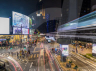 Night street scene in Bukit Bintang with a passing KL Monorail in Kuala Lumpur, Malaysia, Southeast Asia, Asia