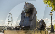 A sphinx on Victoria Embankment, with the London eye in the background, in London, England, United Kingdom, Europe.