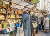 People at an antique book stall at Portobello Road market, in Notting Hill, in London, England, United Kingdom, Europe.
