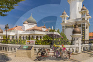 A local rickshaw tuk tuk outside Kapitan Keling Mosque, in George Town, Penang Island, Malaysia, Southeast Asia, Asia.