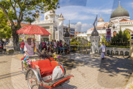 A local rickshaw tuk tuk outside Kapitan Keling Mosque, in George Town, Penang Island, Malaysia, Southeast Asia, Asia.