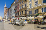 Horse drawn carriage in the main square, Rynek GÅ‚Ã³wny, in the medieval old town, UNESCO World site, in Krakow, Poland, Europe.