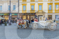 Horse drawn carriage in the main square, Rynek GÅ‚Ã³wny, in the medieval old town, UNESCO World site, in Krakow, Poland, Europe.