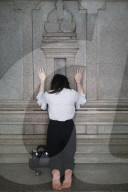 Mariamman Hindu Temple. Worshipper praying on the wall of the sanctuary. Ho Chi Minh city. Vietnam.
