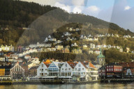 The castellated Kjottbasaren shopping centre (left) & the Fjord Restaurant on the Bryggen waterfront. Bergen, Hordaland, Norway