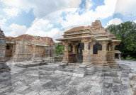 The Sas-Bahu Temples near Udaipur, India consist of two temples and a stone archway. Exquisite carvings depict Hindu dieties.