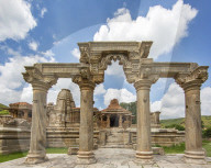 The Sas-Bahu Temples near Udaipur, India consist of two temples and a stone archway. Exquisite carvings depict Hindu dieties.