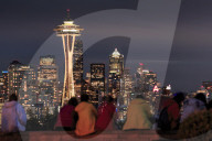 Seattle city skyline at night with illuminated office buildings and Space Needle viewed from public garden near Kerry Park. Seattle, Washington, USA North America