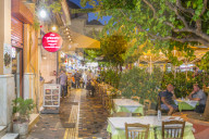 View of Greek restaurants in Monastiraki Square at dusk, Monastiraki District, Athens, Greece, Europe