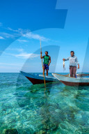 Bajau Fishermen holding an octopus, Togian Islands, Indonesia.