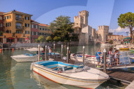 View of Scaliger Castle and boats in harbour, Sirmione, Lake Garda, Lombardy, Italy, Europe