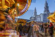 View of carousel and Christmas Market stalls at Christmas Market, Millenium Square, Leeds, Yorkshire, England, UK, Europe