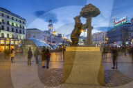 View of Bear and Strawberry Tree statue and Puerta Del Soll at dusk, Madrid, Spain, Europe