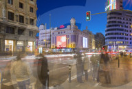View of architecture and trail lights on Gran Via and Plaza del Calao at dusk, Madrid, Spain, Europe