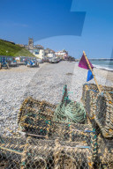 View of fishing baskets on the beach and Parish Church overlooking pier on a summer day, Cromer, Norfolk, England, United Kingdom, Europe