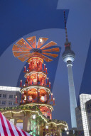Christmas Pyramid at Christmas market in Alexanderplatz with Fernsehturm television tower behind, Berlin-Mitte, Berlin, Germany