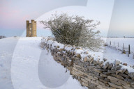Broadway Tower and dry stone wall in winter snow, Broadway, The Cotswolds, Worcestershire, England, United Kingdom, Europe