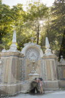 Woman using water fountain, Quinta da Regaleira, Sintra, Portugal