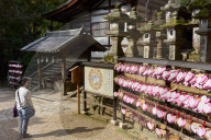 Stone lanterns & heart-shaped votives wishing good luck to new marriages at Kasuga Wakamiya Shrine in Nara.