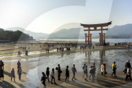 The red wooden torii gate at low tide on Miyajima island.